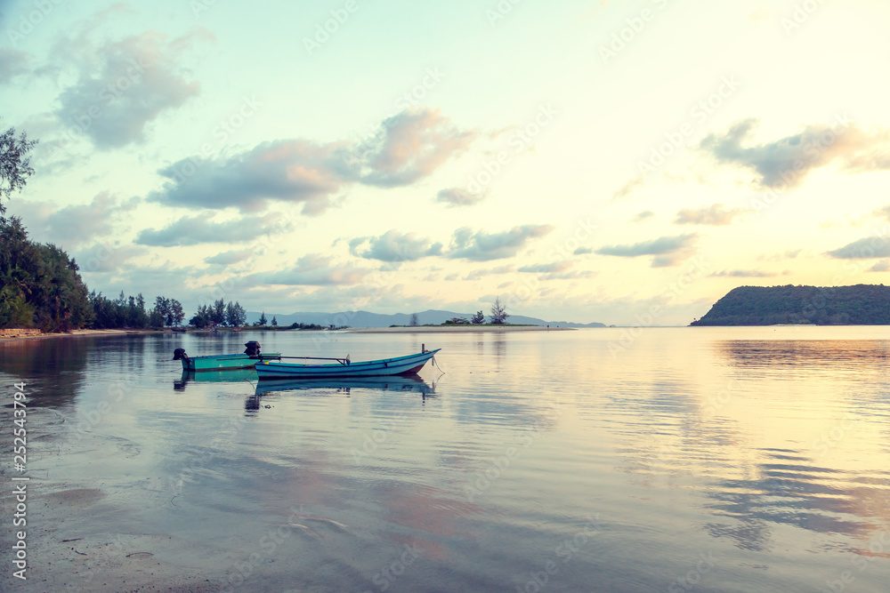 Blue sea at sunset, boat fishing  Shore landscape bay. Summer beautiful   scenery. Blue water.