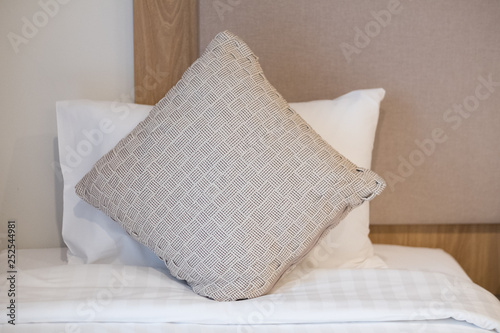 Fototapeta Naklejka Na Ścianę i Meble -  Close up of brown pillows on cozy bed