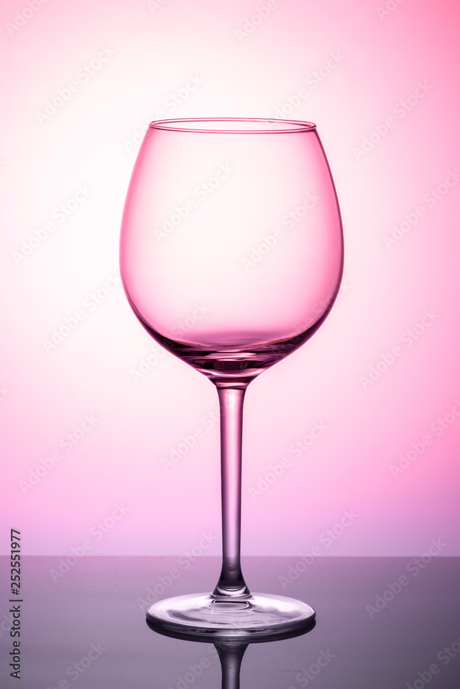 glass of wine isolated on pink background