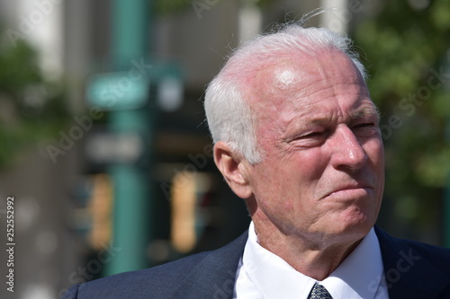 Unemotional Adult Senior Business Man Wearing Suit And Tie Downtown photo