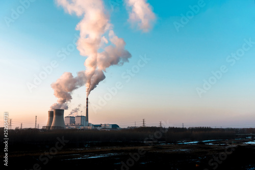 silhouette of industrial factory smoke stack of coal power plant from chimney up on sky cause air pollution and destroy the Earth's atmosphere.
