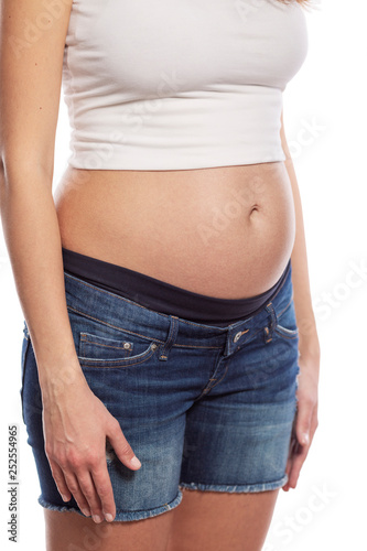 Pregnant young woman. Early term. Isolated on a white background. Vertical. © Анна Демидова