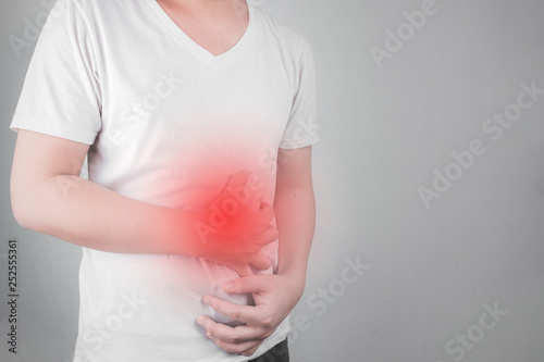 Asian Young men are suffering from stomach ulcers. gastritis Caused by the infection of H. pylori bacteria healthcare and health problem concept