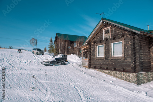 Village in the winter. Houses in Siberia under the snow. Buildings in the snow. Countryside in winter.