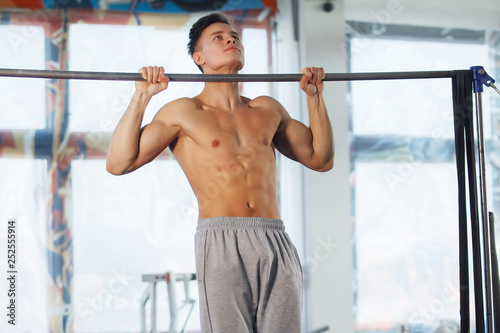 Man making exercises on crossbar.