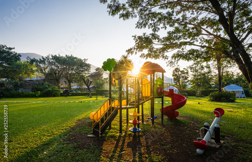Colorful playground and sunrise  on yard in the park photo