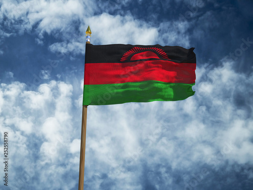 Malawi flag Silk waving flag of Malawi made transparent fabric with wooden flagpole gold spear on background sunny blue sky white smoke clouds real retro photo Countries of world 3d illustration photo