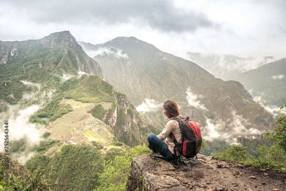 Fototapeta premium Girl-hiker looking on top of Huayna Picchu, looking on Machu Picchu