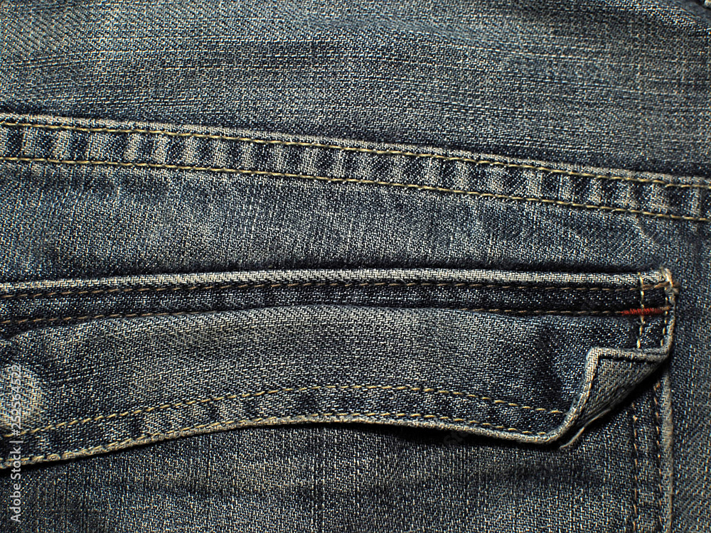 Old faded blue jeans. Macro. Pocket on old blue jeans. Old faded blue jeans. Macro. Pocket on old blue jeans.