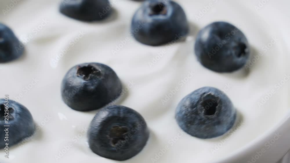 Closeup Blueberries in natural yogurt rotating. 4k. Fruit background. Closeup Blueberries in natural yogurt rotating. 4k. Fruit background.
