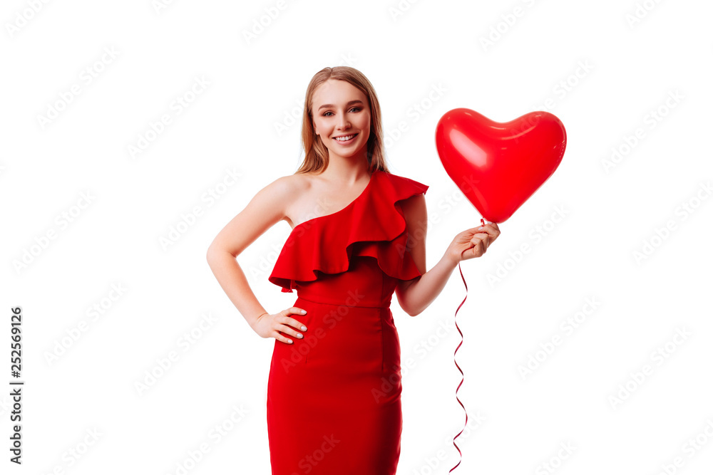Attractive young girl in red dress holding Valentine's Day helium balloon. Love concept. Attractive young girl in red dress holding Valentine's Day helium balloon. Love concept.