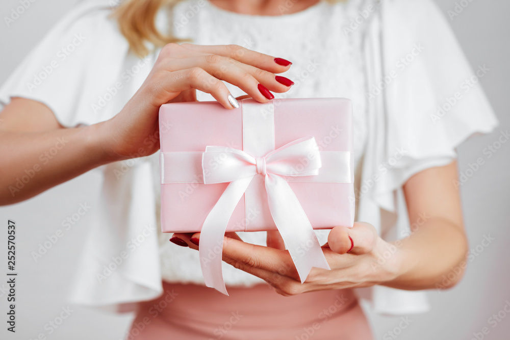 woman hands holding pink gift box on white background woman hands holding pink gift box on white background