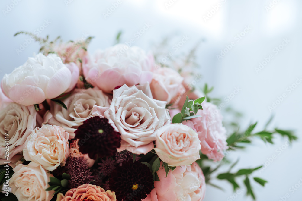 Spring bouquet of mixed flowers on vintage gray wall background behind