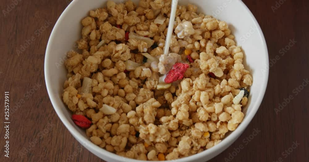 Adding milk into cereal Adding milk into cereal