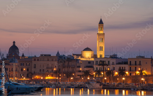 Cityscape of Bari at sunset with Basilica of San Nicola and Romanesque Cathedral. Bari, Puglia, Italy. seafront city view from marina at night. Apulia region