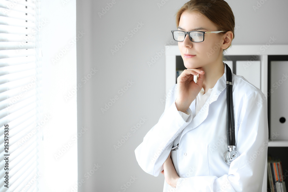 Doctor woman at work. Portrait of female physician at hospital office. Medicine and healthcare concept Doctor woman at work. Portrait of female physician at hospital office. Medicine and healthcare concept