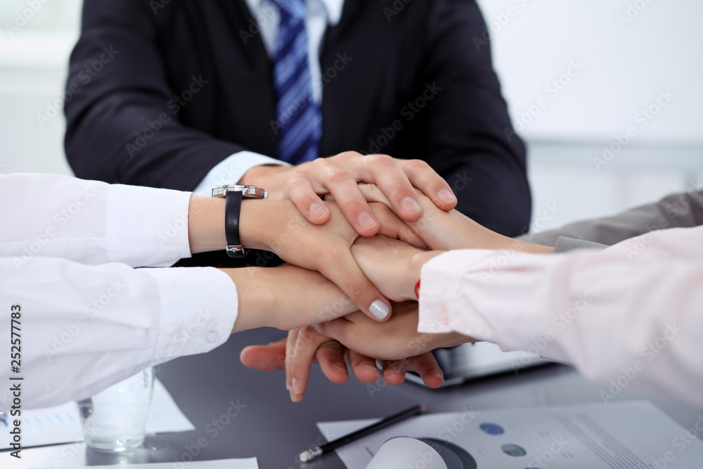 Obraz premium Business people group joining hands and representing concept of friendship and teamwork. Meeting of success team