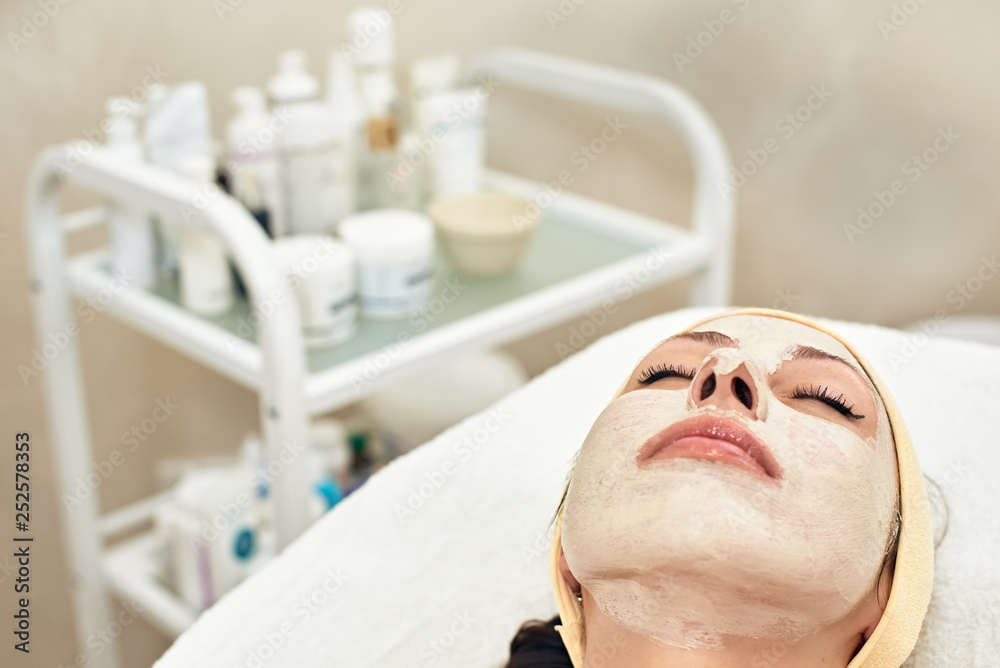 Portrait of attractive young woman lying in beauty salon with mask on her face Portrait of attractive young woman lying in beauty salon with mask on her face