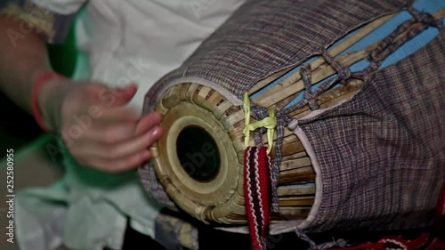 Hare Krishna Man Playing Traditional Indian Instrument Mridanga Close-up.