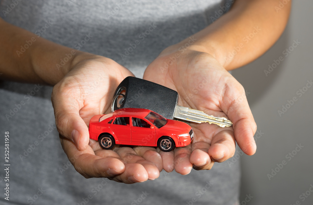 Fototapeta premium Car toy and key in hand.