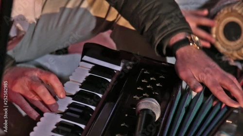 Hare Krishna Man Playing Traditional Indian Instrument Harmonium Close-up.
