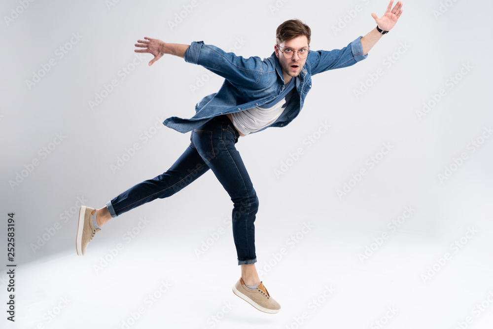 Full length portrait of a happy excited man jumping and looking at camera isolated over white background. Full length portrait of a happy excited man jumping and looking at camera isolated over white background.