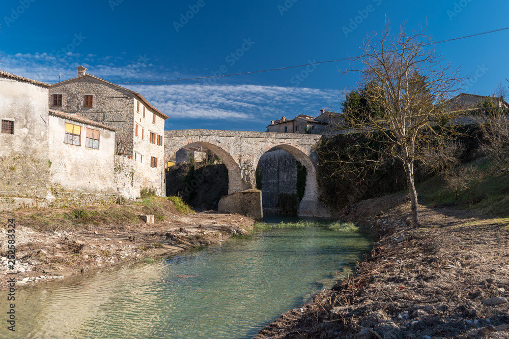 Naklejka premium The medieval bridge over the river Metauro in Mercatello sul Metauro (Pesaro-Urbino province)