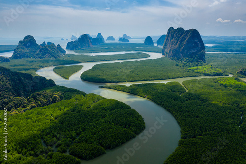 Aerial drone view of towering limestone cliffs and mangrove forest in Phang Nga Bay, Thailand