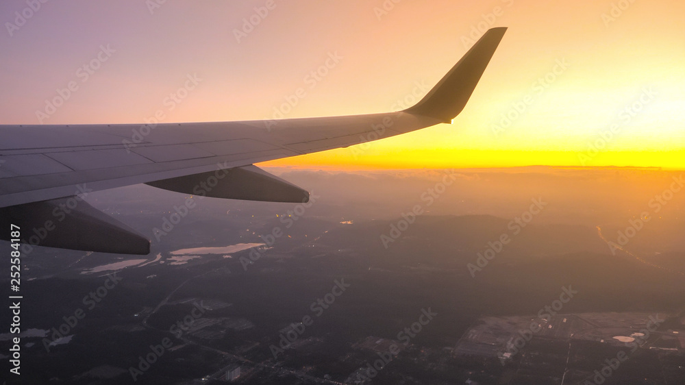 Sunset time Above the clouds.Wing aircraft on the sky Sunset time Above the clouds.Wing aircraft on the sky