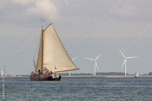 A genuine authentic Dutch sailing vessel sailing in the nature reserve the Oosterschelde in the Netherlands © Ramon