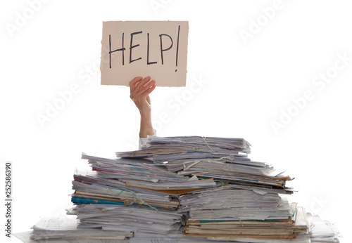 Person under a pile of papers with a hand holding a sign of help. Accounting.