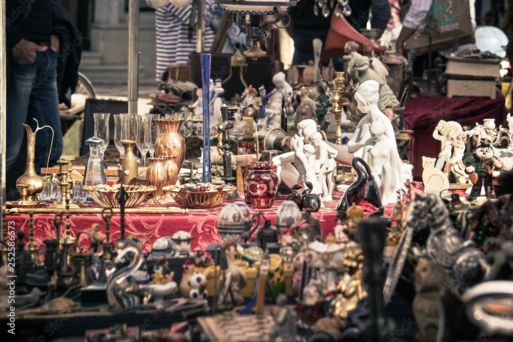 collection of old objects on a flea market, selective focus on aged kitsch junk