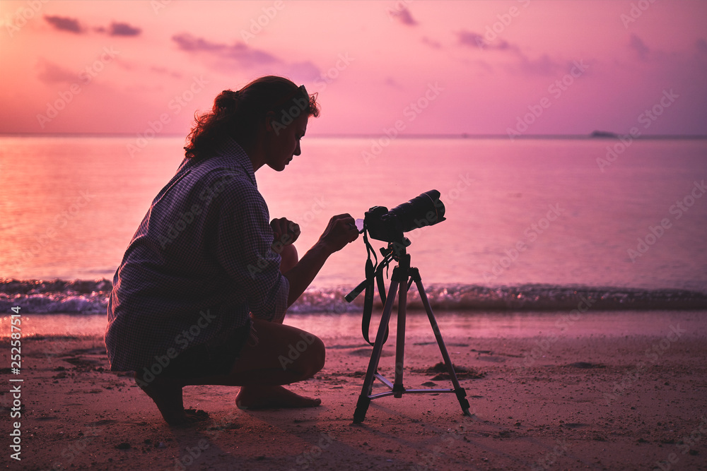 Woman photographer, taking pictures of sunset