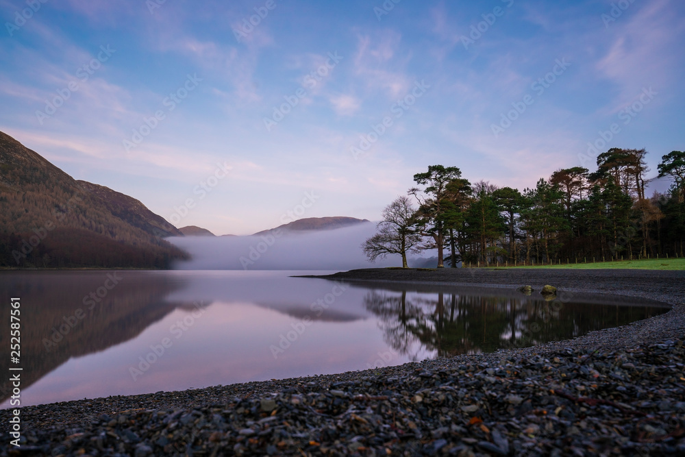 sunrise over trees on the eastern side of Buttermere, The Lake Distict,UK