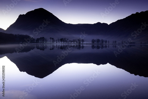 sunrise over trees on the eastern side of Buttermere, The Lake Distict,UK photo