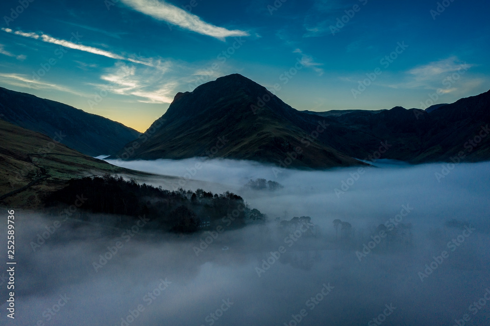 sunrise over trees on the eastern side of Buttermere, The Lake Distict,UK