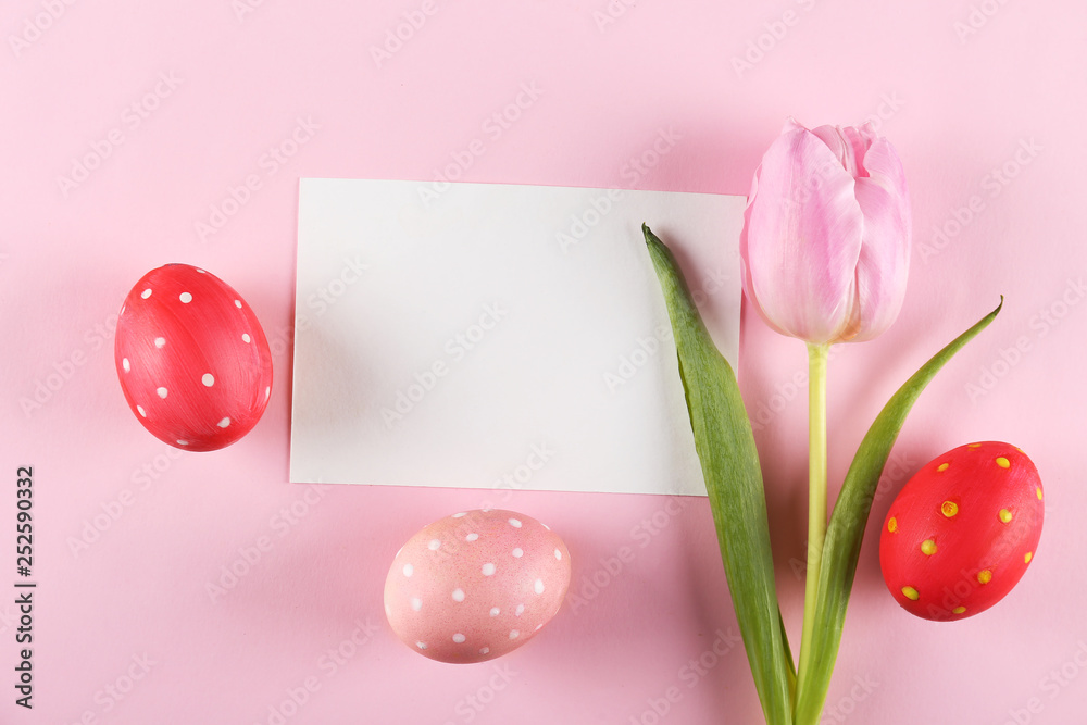 Hand painted polka dot Easter eggs of different pastel color on bright colorful paper background with a lot of copy space for text. Top view, flat lay, close up. Blank Easter greeting card concept.