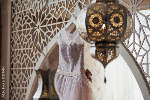 A beautiful wedding dress in pink in a Moroccan style room.
