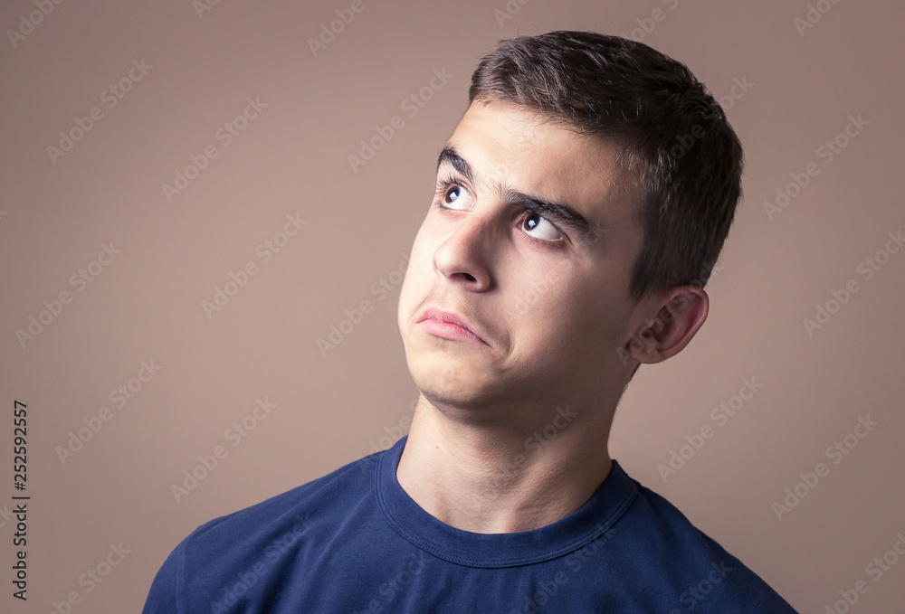 Obraz premium Closeup portrait confused young man. Human facial expression, emotion, feeling, sign symbol body language