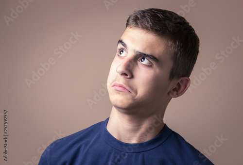 Closeup portrait confused young man. Human facial expression, emotion, feeling, sign symbol body language