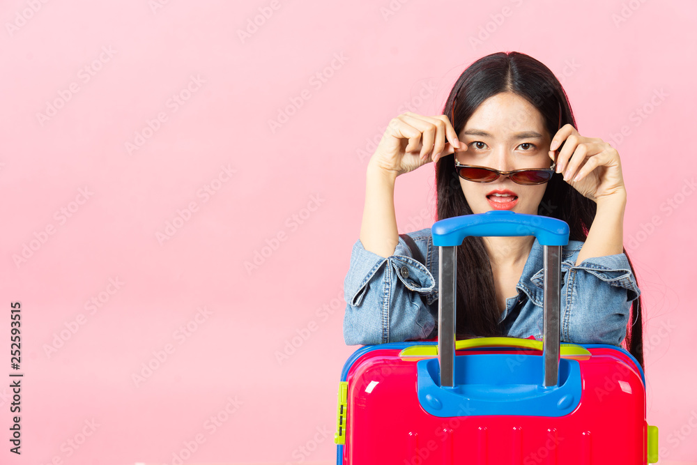 Traveler tourist woman in summer casual clothes.Asian Smiling woman wearing sun glasses.Passenger traveling abroad to travel on pink background. Traveler tourist woman in summer casual clothes.Asian Smiling woman wearing sun glasses.Passenger traveling abroad to travel on pink background.