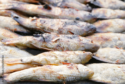 Close up dried grilled fish placed on zinc