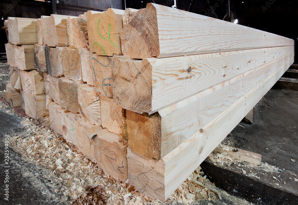 Wood at the sawmill. Lumber is stored in the warehouse. Wood at the sawmill. Lumber is stored in the warehouse.