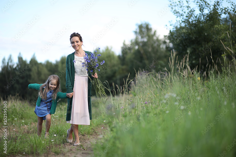 Mother with daughter walking on a road Mother with daughter walking on a road