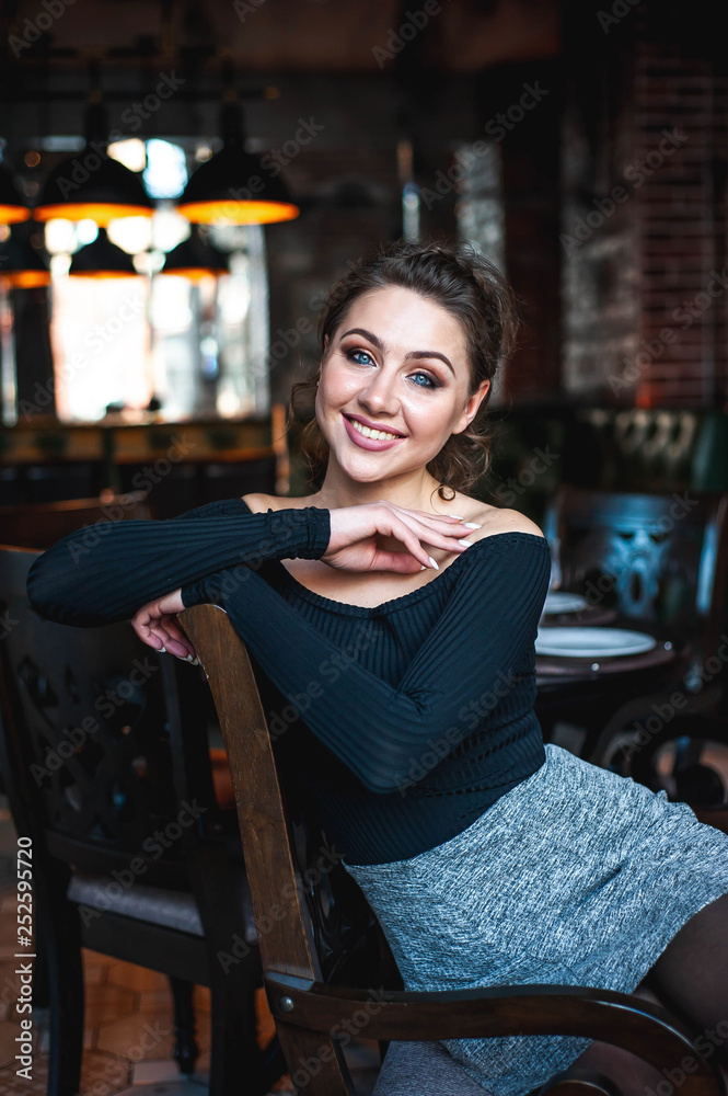 portrait of a beautiful girl, a girl sits on a chair in a cafe portrait of a beautiful girl, a girl sits on a chair in a cafe