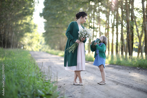 Mother with daughter walking on a road