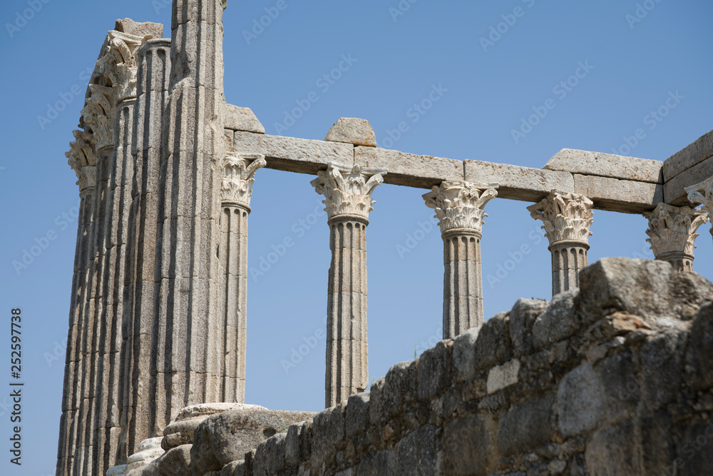 Roman ruins of columns against the blue sky.