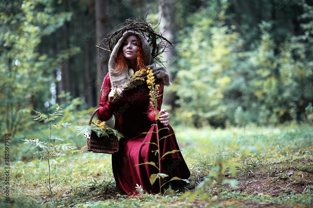 The red-haired witch holds a ritual with a crystal ball The red-haired witch holds a ritual with a crystal ball