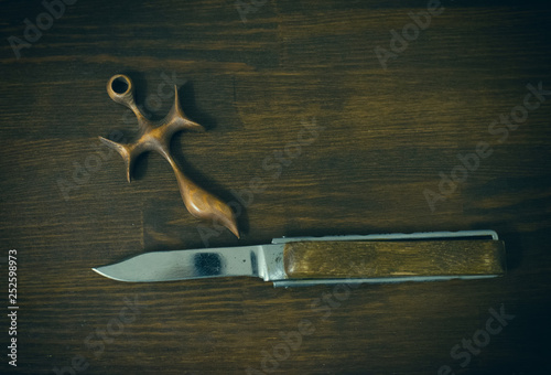 knife and wooden cross photo