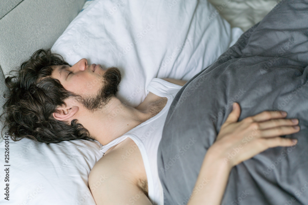 Cute handsome young man sleeping on bed. Cute handsome young man sleeping on bed.